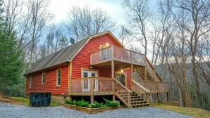 A red log cabin with a balcony and a staircase leading to a second floor. - Hot Tub Soaks Under the Stars, Firepit S'mores & Secluded Mountain Vibes - A Country Retreat (Gatlinburg)