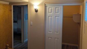 A bedroom with a bed, a door, and a hallway leading to a bathroom. - Heavenly Gates (South Lake Tahoe)