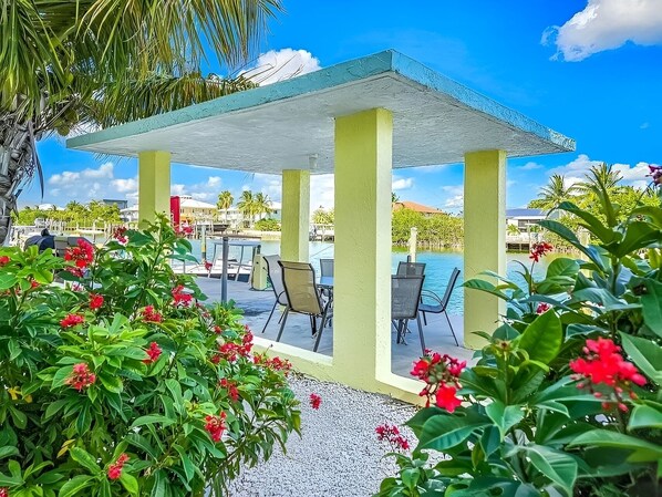 Outdoor dining - Welcome to REEL HIP!<br><br>Dive into your ultimate Florida Keys retreat at Reel Hip! This stylish waterfront condo offers the perfect blend of coastal charm and modern luxury, complete with a heated pool and a private boat slip for your dream getawa (Marathon)