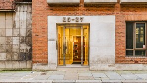 A building entrance with a glass door and the number 36-37 above it.