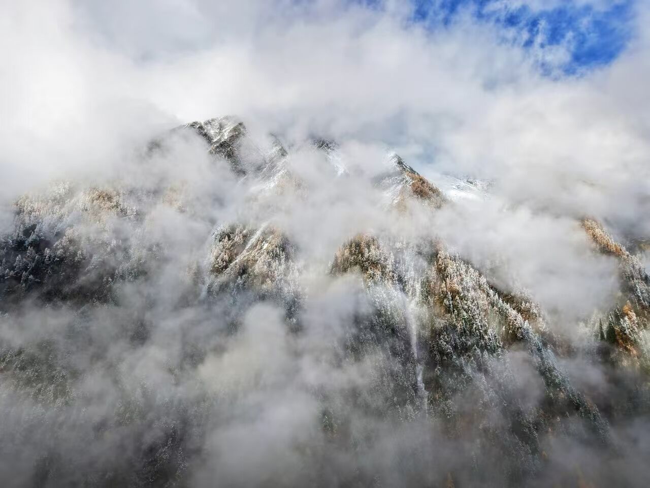 A mountain range partially obscured by clouds.