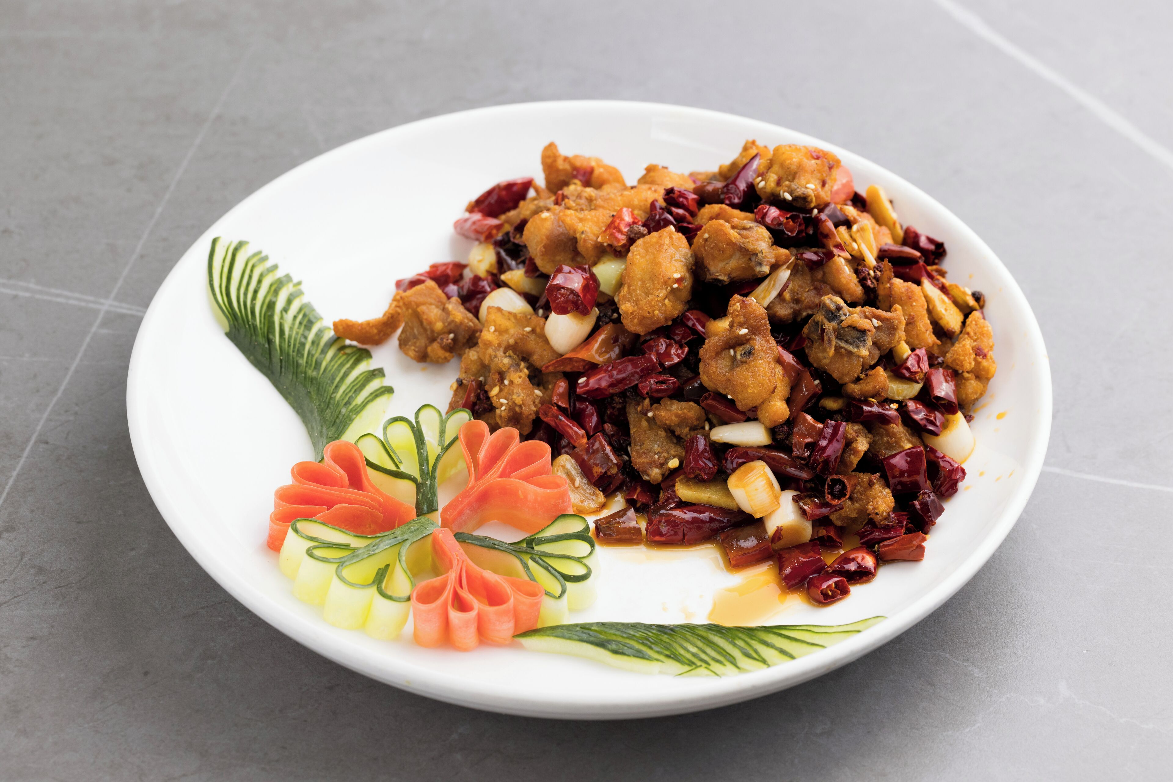 A plate of food with a decorative arrangement of vegetables.