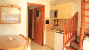 A compact kitchen with wooden cabinets, a dishwasher, and a wooden staircase. - Barbessine Bbb11 SUN & Chair Lift 5 Pers (Chatel)