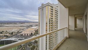 A high-rise building with a balcony overlooking a cityscape. - SVS: Penthouse 2BD/3BA | Mountain View Balcony | Full Kitchen | MGM (Las Vegas)
