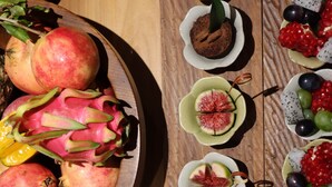 A variety of food items including fruits, pastries, and salads arranged on a wooden table. - Shanxun Snow Mountain Villa Hotel (Guilin)