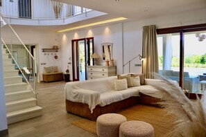 A spacious bedroom with a large bed, a staircase, and a view of the outdoors. - Ca`n Mutxo, stunning views, swimming pool and barbecue (Biniamar)