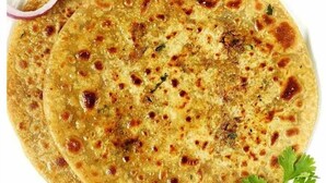 A flatbread with visible herbs and spices. - Nimantrana (Noida)