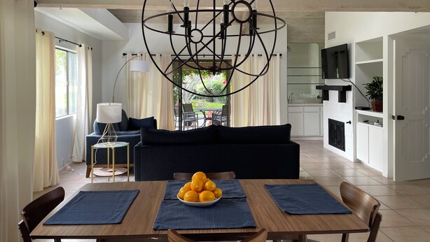 A modern kitchen with white cabinets, a built-in oven, and a TV above the counter. - Quiet, comfortable 2-bedroom condo at Mission Hills in Rancho Mirage (Rancho Mirage)