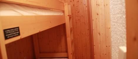 A bunk bed with a wooden frame and a label on the side.