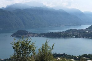 A panoramic view of a mountainous landscape with a lake and a small island.