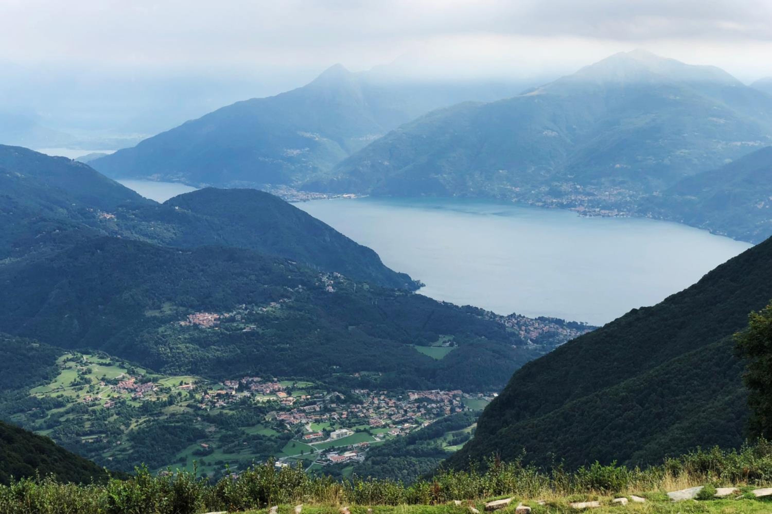 A mountainous landscape with a lake and a town in the valley.