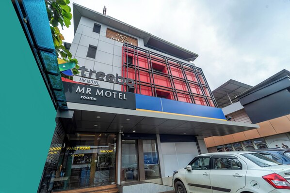 A modern motel building with a prominent sign for 'Mr Motel' and 'Family Rooms.' - Treebo MR Motel, 10 Mins To Airport (Iritty)