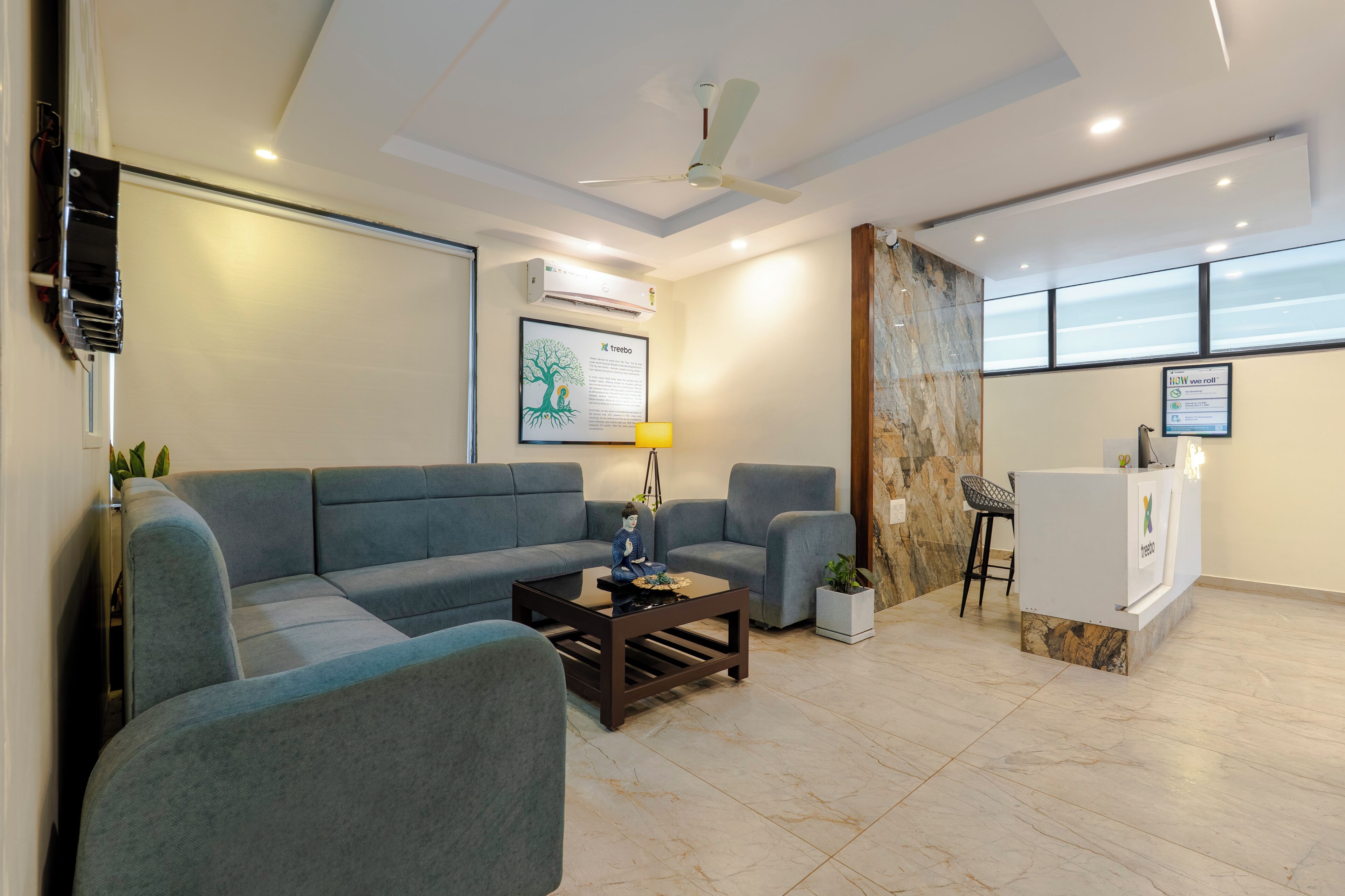 A modern living room with a sofa, armchairs, a coffee table, and a small bar area.