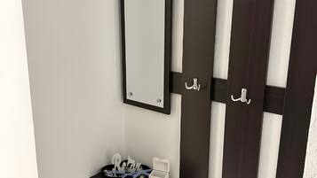 A modern room with a black and white vanity, a mirror, and a small table with a nameplate.