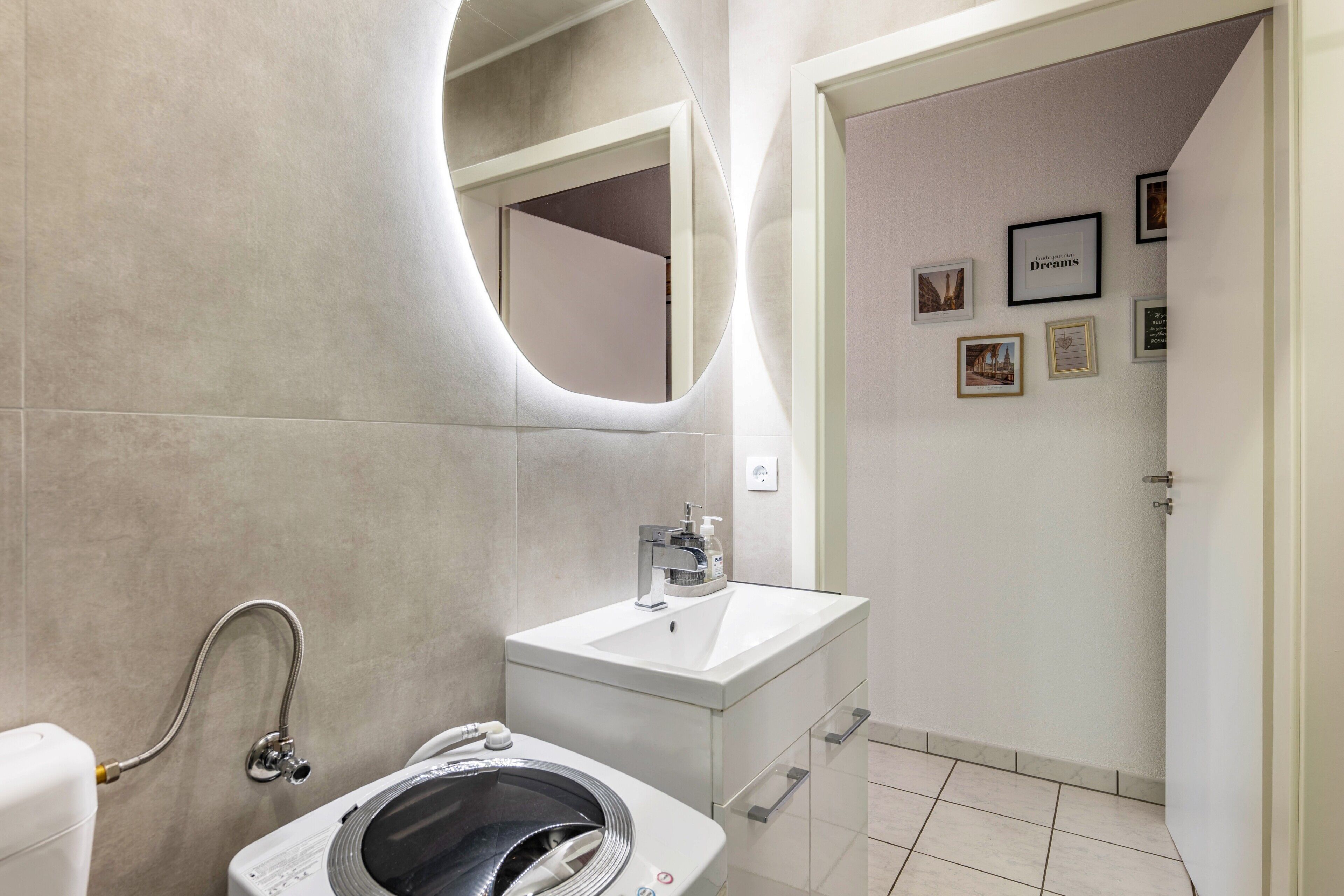 A modern bathroom with a toilet, bidet, and sink.