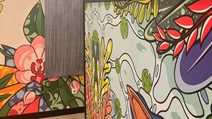 A hallway with colorful murals and a number '2' sign. - Alltrue Hotel Palangkaraya (Palangkaraya)