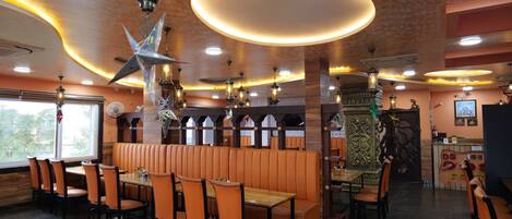 A restaurant with booths, tables, and chairs.