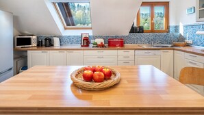 A kitchen with a wooden countertop, a microwave, a coffee maker, and a sink. - Holiday Home with Mountain View, Large Terrace and Wi-Fi (Baden-Baden)