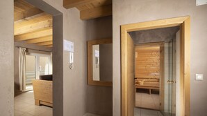 A modern bathroom with a wooden bench, a mirror, and a shower area. - Villa Chiara with a private pool and sauna (Premantura)
