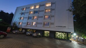 A multi-story hotel with a modern design, featuring a prominent 'Hotel Woodland' sign. - The Fern Residency Pune, Woodland, Series by Marriott (Pune)