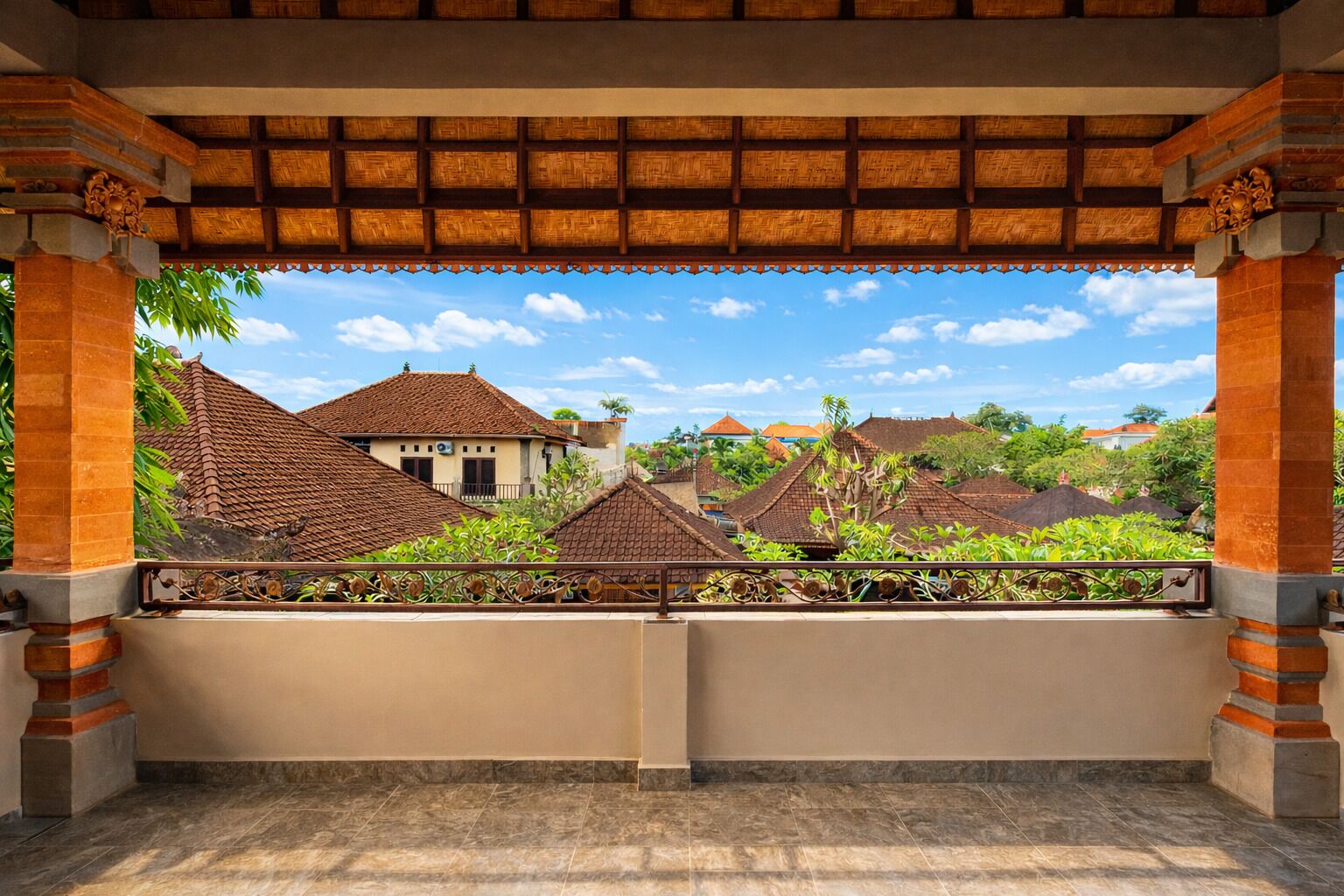 A balcony with a view of traditional buildings and a clear sky.