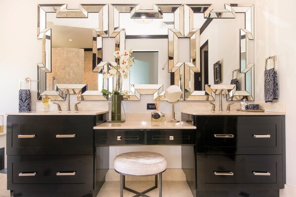 A bathroom with two sinks, black cabinets, and a large mirror. - Villa Essencia in Brasilito (Cabo Velas)