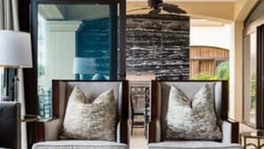 A modern living room with two sofas, a coffee table, and a fireplace. - Villa Essencia in Brasilito (Cabo Velas)