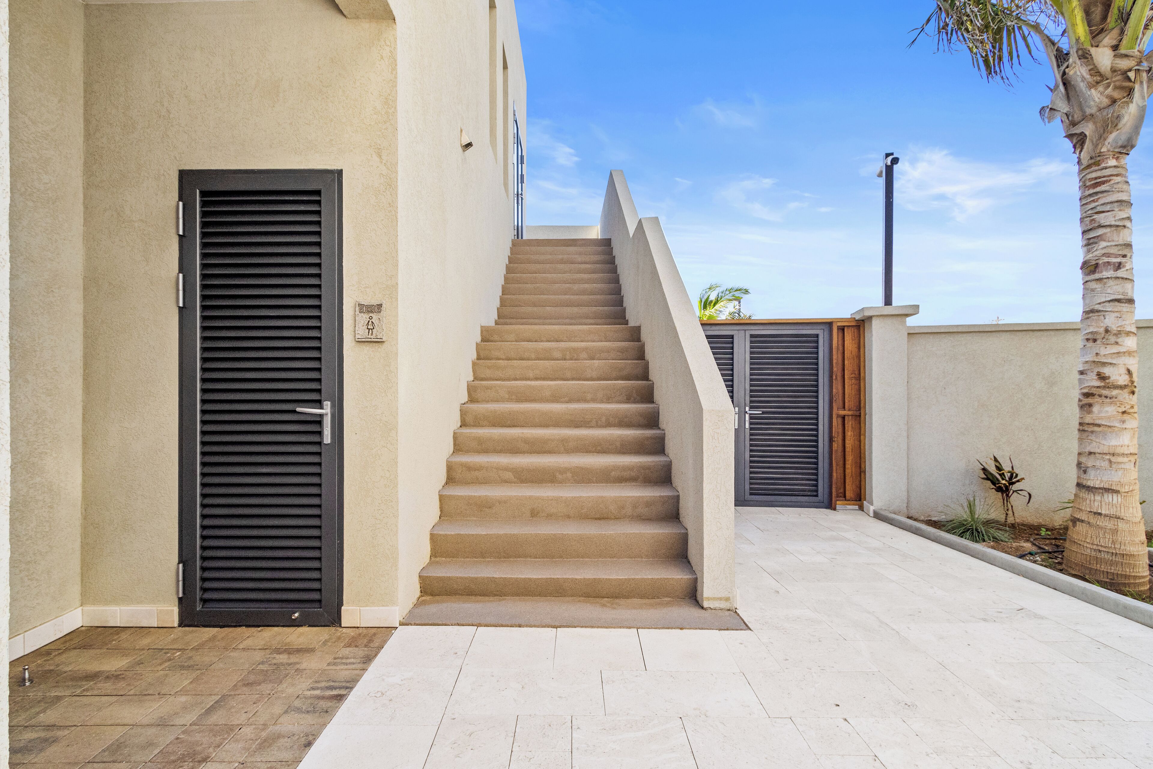 A staircase leading to a door with a sign indicating a handicap accessible entrance.