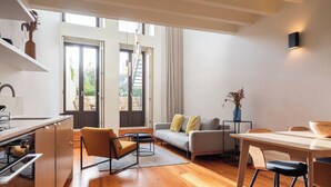 A modern living space with a kitchen, dining area, and seating area.
