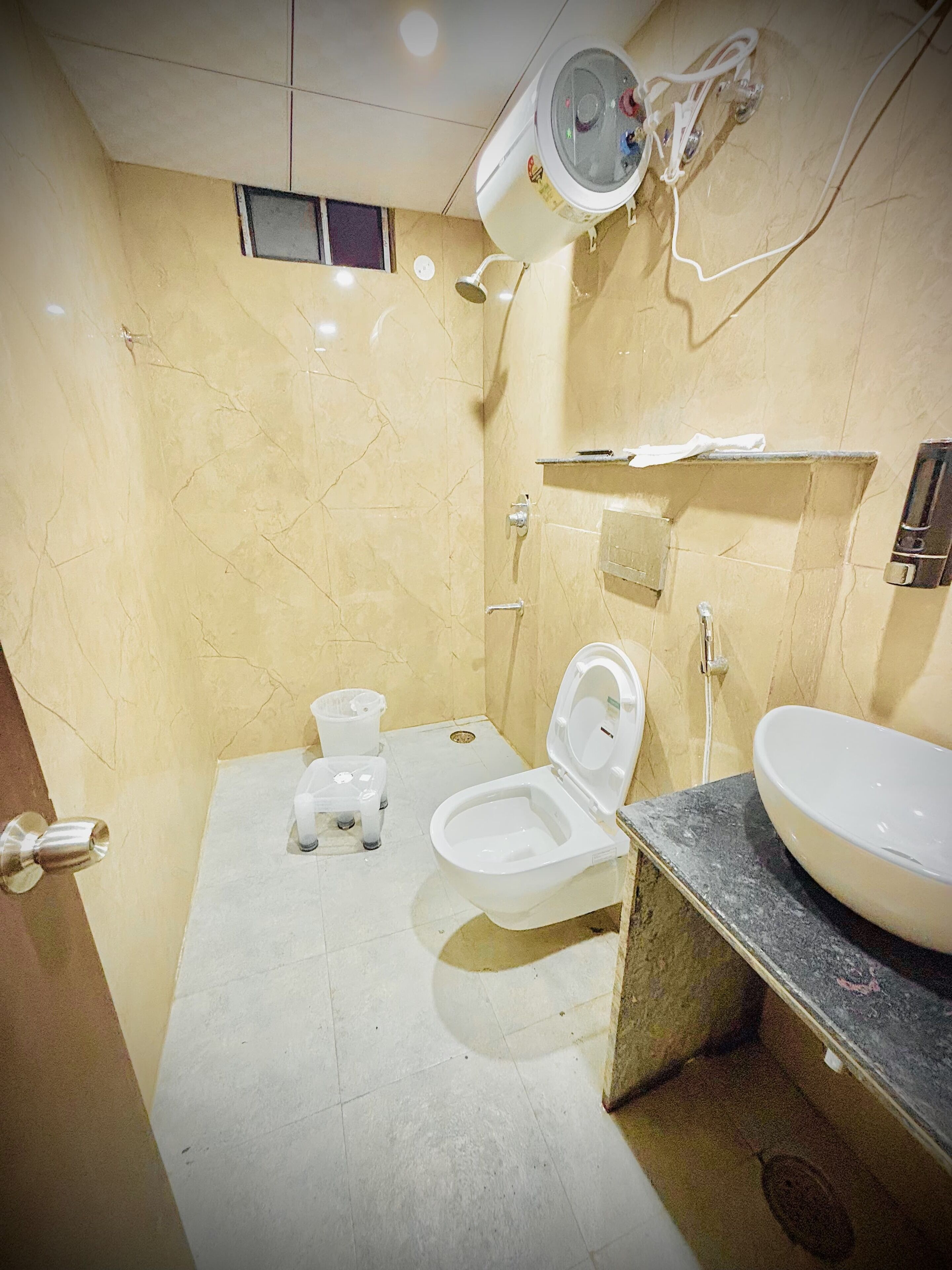 A bathroom with a toilet, bidet, and sink.