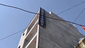 A tall building with a sign reading "TRAVELER'S SOHO". - Twamev Residency  (New Delhi)