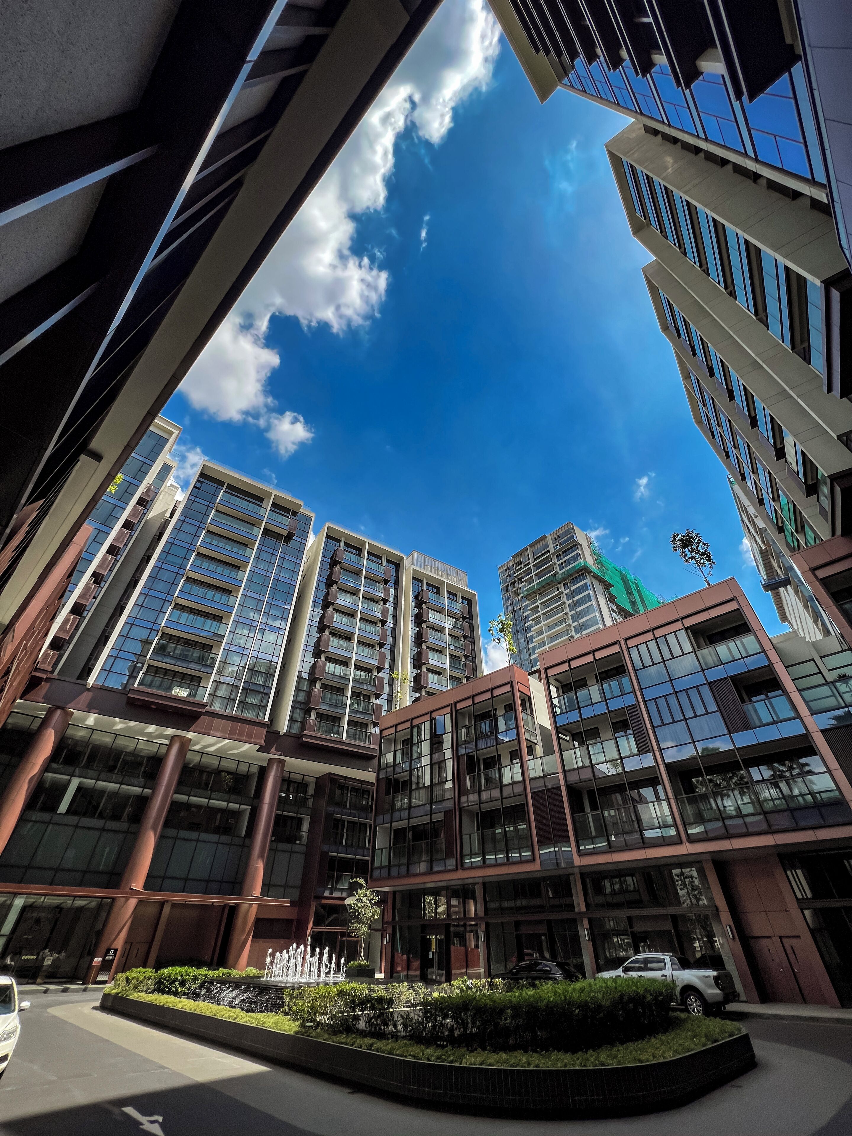 A modern building with multiple floors, large windows, and a clear sky.