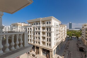 A multi-story building with balconies, large windows, and a clear view of the surrounding area. - Boulevard 114 (Tashkent)