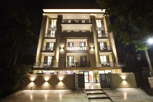 A multi-story hotel with a prominent entrance and balconies.