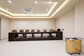 A reception area with a marble counter displaying shoes, a ceiling light fixture, and a cart. - Saltstayz Premier – Golf Course Road & Sector 42 (Gurugram)