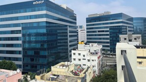 A modern office building with a glass facade and a sign that reads "Bezos". - AXON Bellandur by AXON Hotels (Bengaluru)
