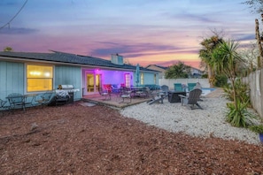 A house with a patio area, outdoor furniture, and a pool.