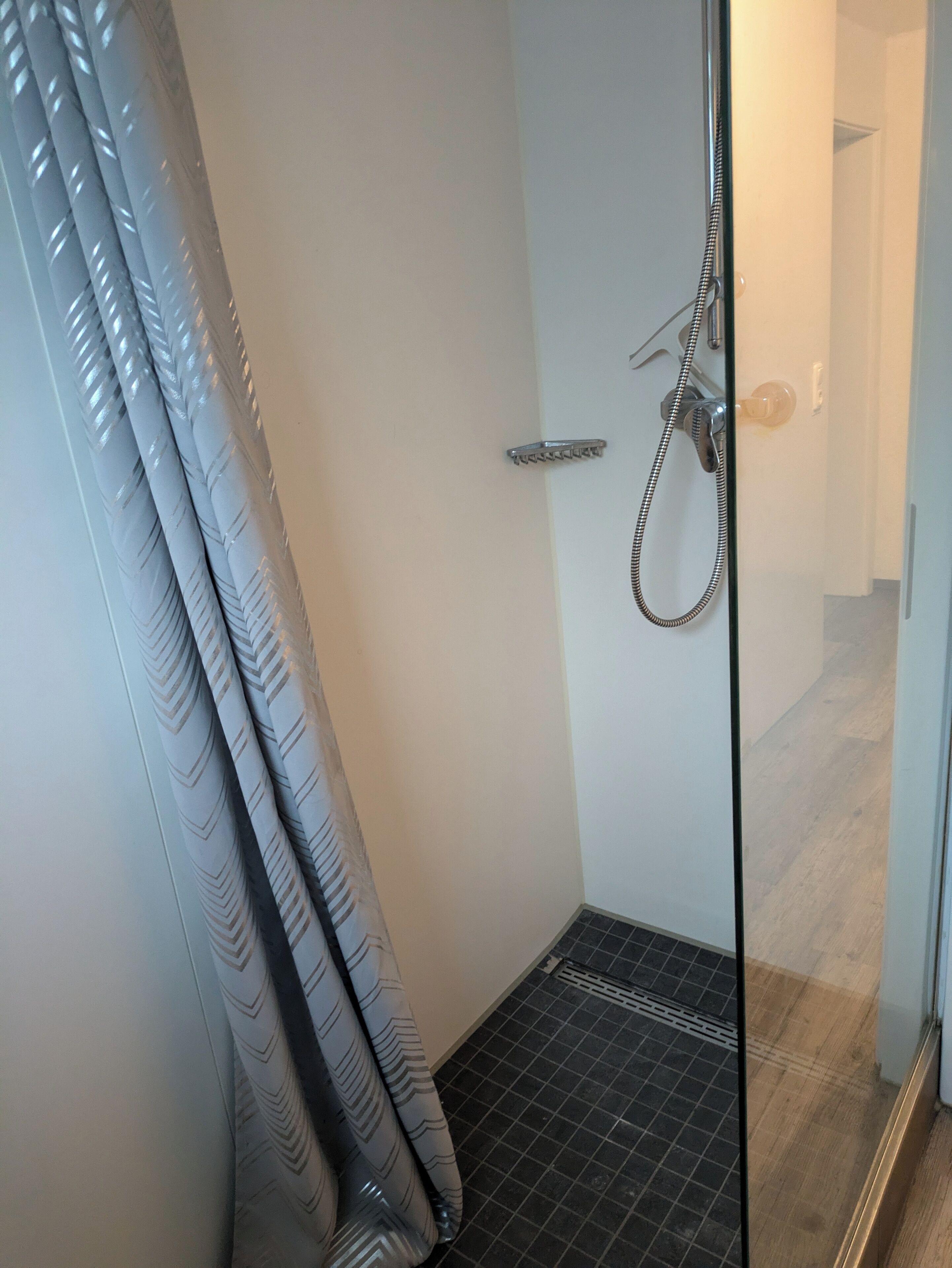 Regadera, piso con calefacción, toallas, papel de baño 