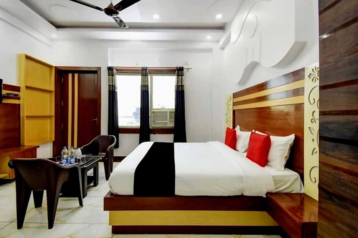 A hotel room with a bed, a desk, and a chair.