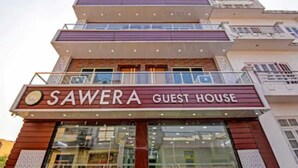 A multi-story building with a sign reading "SAWERA GUEST HOUSE". - The Sawera- Haridwar (Haridwar)