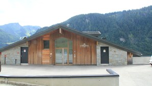 A wooden building with a stone facade, labeled "L'IMPÉRIAL," set against a mountainous backdrop. - Imperial Ip402 Cosy & View 4 Pers (Chatel)