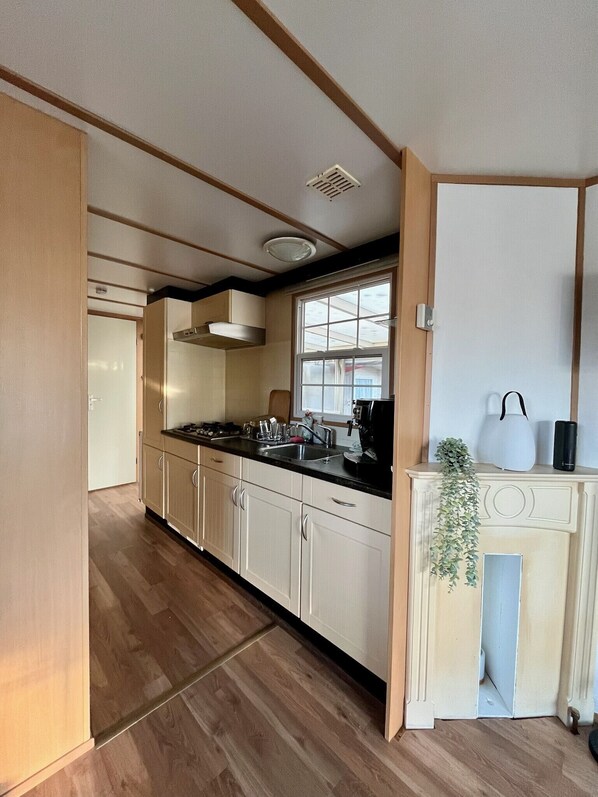 Fridge, coffee/tea maker, electric kettle, cookware/dishes/utensils