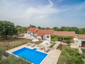 A residential property with a swimming pool, outdoor seating, and a garden. - Villa Vitis ZadarVillas (Oklaj)