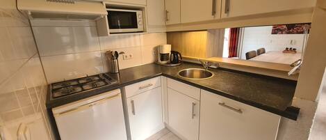 Fridge, coffee/tea maker, electric kettle, cookware/dishes/utensils