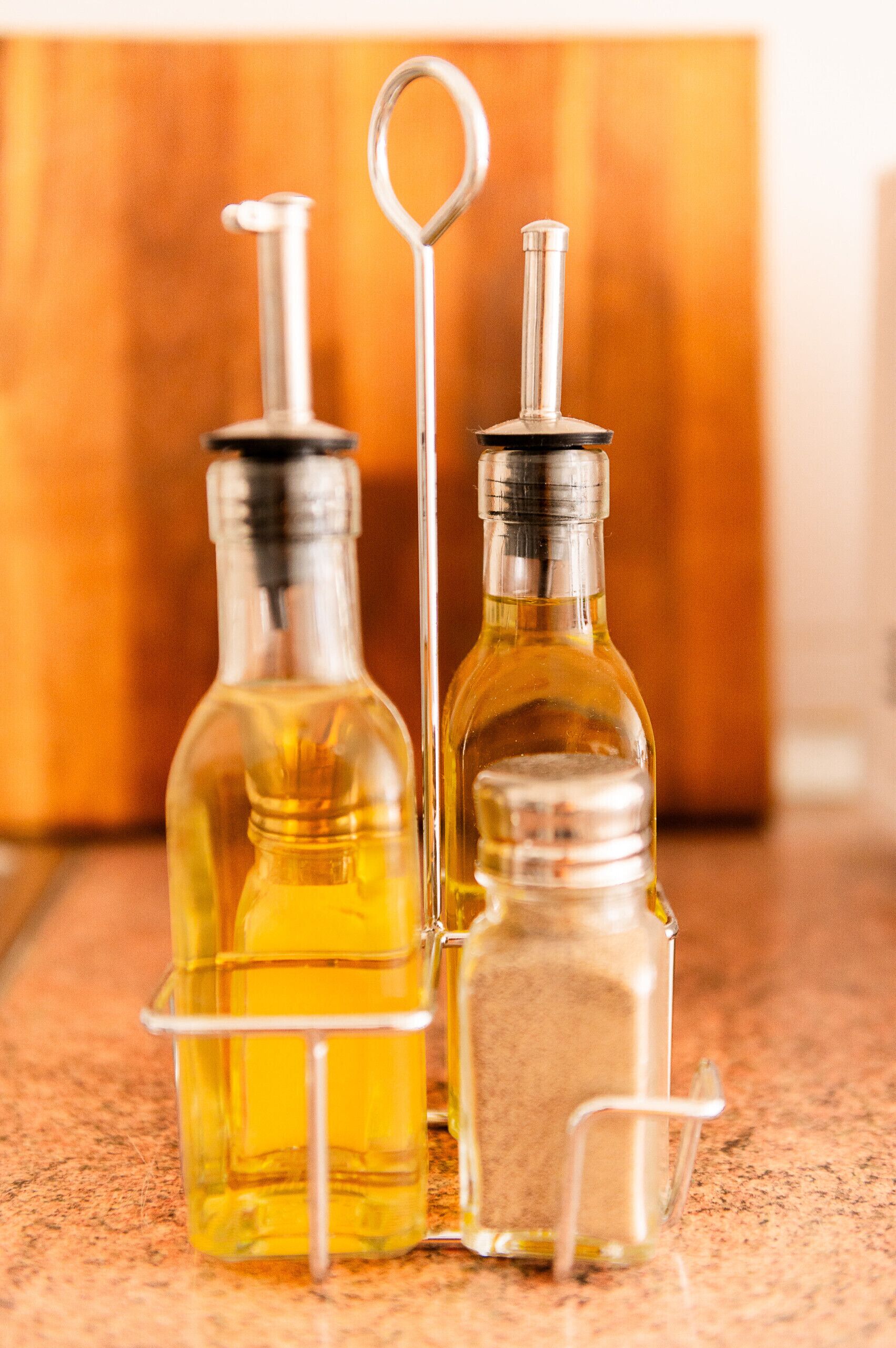 Two glass bottles with metal stoppers on a countertop.