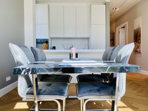 Enjoy meals in this stylish dining area with a marble table and comfortable chairs.