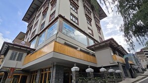 Un hotel con fachada tradicional, un cartel que dice 'The Seva Hotel' y una entrada moderna con un balcón de madera.