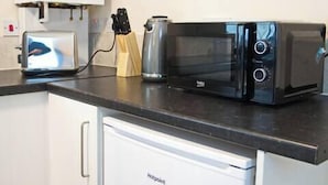 A kitchen with a toaster, a microwave, a coffee maker, and a dishwasher. - Host Stay Clacton Waves (Clacton-on-Sea)