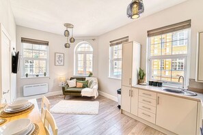 A modern kitchen with a dining area, large windows, and a cozy seating area. - Host Stay Taylor Bennett Apartment (Worcester)