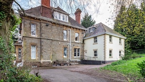 A two-story stone building with a traditional design, featuring a stone facade and a white upper section. - Host Stay Hillbrook House Apartment (Malvern)
